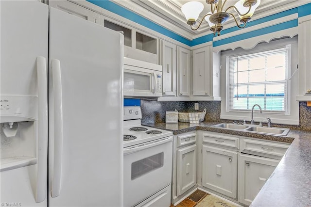 kitchen with decorative backsplash, white appliances, sink, crown molding, and an inviting chandelier