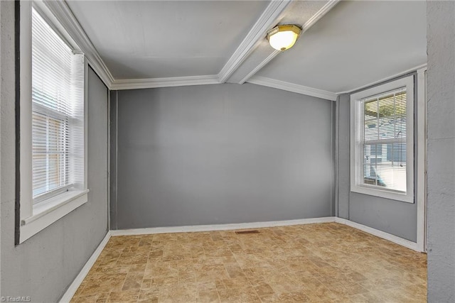 spare room featuring ornamental molding and beamed ceiling