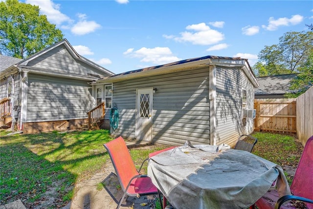 rear view of house with a yard and a patio