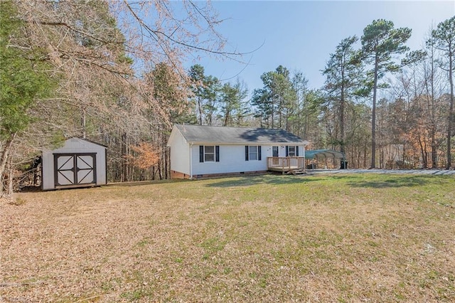 view of front of house featuring an outbuilding, a front yard, a storage unit, crawl space, and a deck