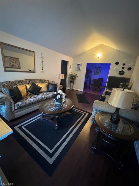 living room featuring dark wood-type flooring and lofted ceiling