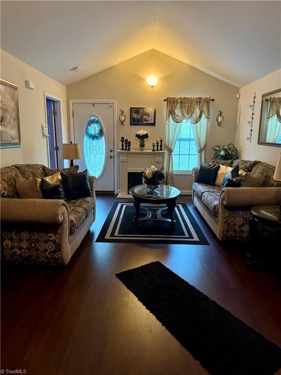 living room featuring dark hardwood / wood-style floors and lofted ceiling