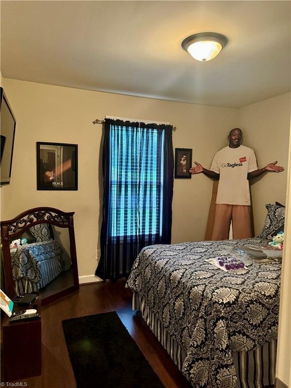 bedroom with hardwood / wood-style flooring