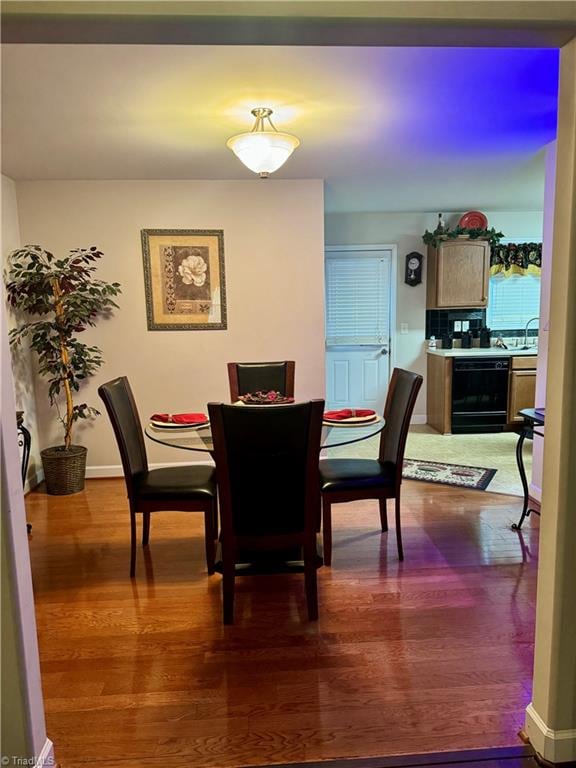 dining room featuring wood-type flooring and sink