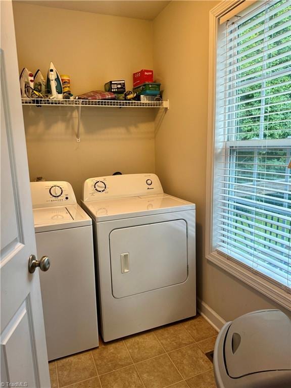 washroom with washing machine and dryer and light tile patterned floors