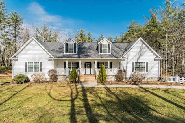 cape cod house featuring a front yard, covered porch, and fence