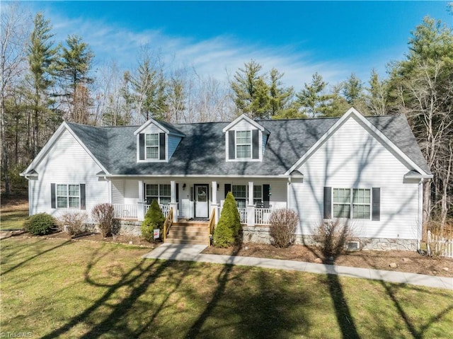 new england style home with a porch and a front lawn