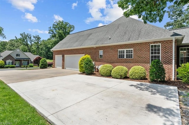 320 N Club Dr, Asheboro, NC 27205 - view of side of property featuring brick siding, concrete driveway, a shingled roof, and an attached garage