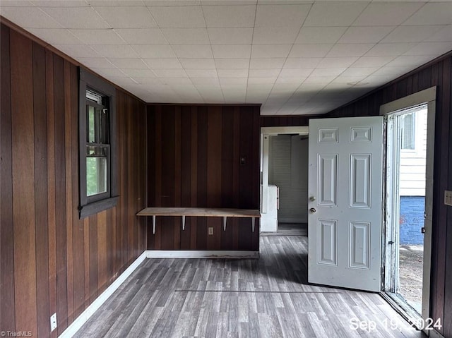 spare room featuring hardwood / wood-style floors and wooden walls