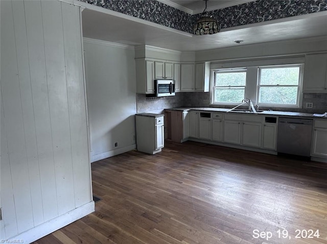 kitchen featuring stainless steel appliances, backsplash, dark wood-type flooring, and wooden walls