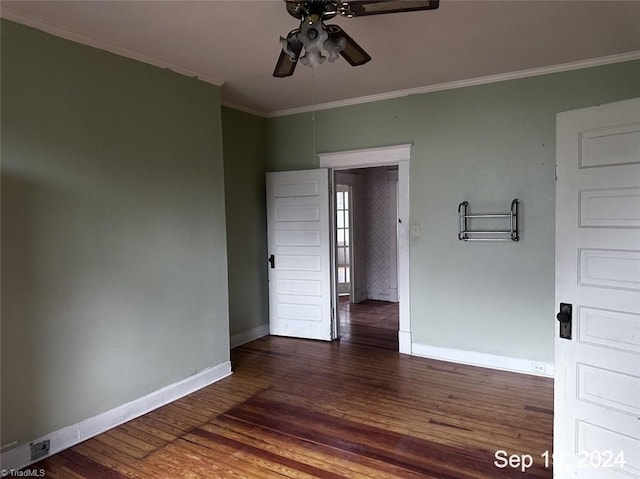 spare room with dark hardwood / wood-style floors, crown molding, and ceiling fan