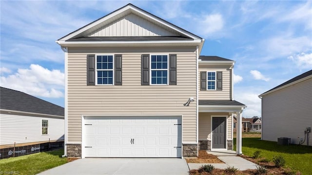 view of front of house with stone siding, an attached garage, and concrete driveway