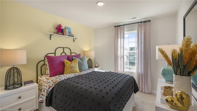 bedroom with visible vents and light colored carpet