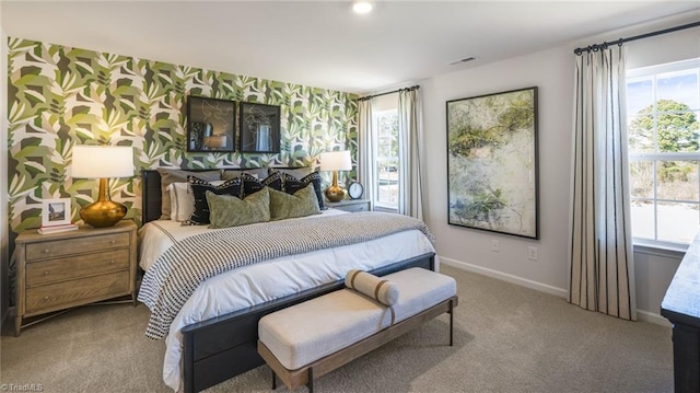 bedroom with wallpapered walls, visible vents, baseboards, and light colored carpet