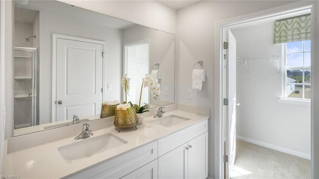 bathroom featuring a sink, baseboards, and double vanity