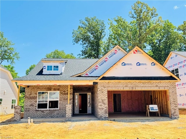 1087 Fairhaven Dr Lot 48, Mebane, NC 27302 - property under construction with brick siding, a garage, roof with shingles, and driveway