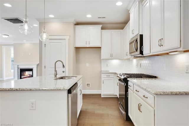 1087 Fairhaven Dr Lot 48, Mebane, NC 27302 - kitchen featuring appliances with stainless steel finishes, a sink, wood finished floors, white cabinets, and recessed lighting