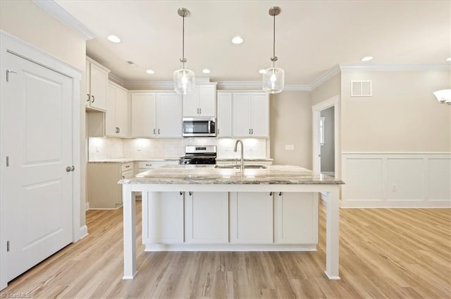 1087 Fairhaven Dr Lot 48, Mebane, NC 27302 - kitchen with appliances with stainless steel finishes, a sink, crown molding, white cabinets, and light wood finished floors