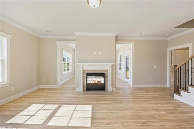 1087 Fairhaven Dr Lot 48, Mebane, NC 27302 - unfurnished living room with stairway, a multi sided fireplace, light wood-style flooring, crown molding, and baseboards