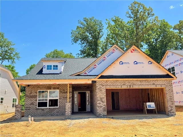 1087 Fairhaven Dr Lot 48, Mebane, NC 27302 - unfinished property featuring brick siding, an attached garage, and roof with shingles