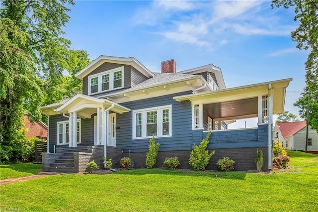 view of front of house with a chimney and a front lawn