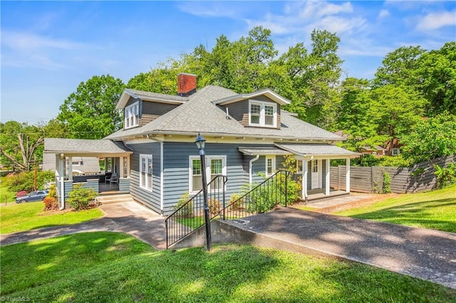 bungalow with a chimney and roof with shingles
