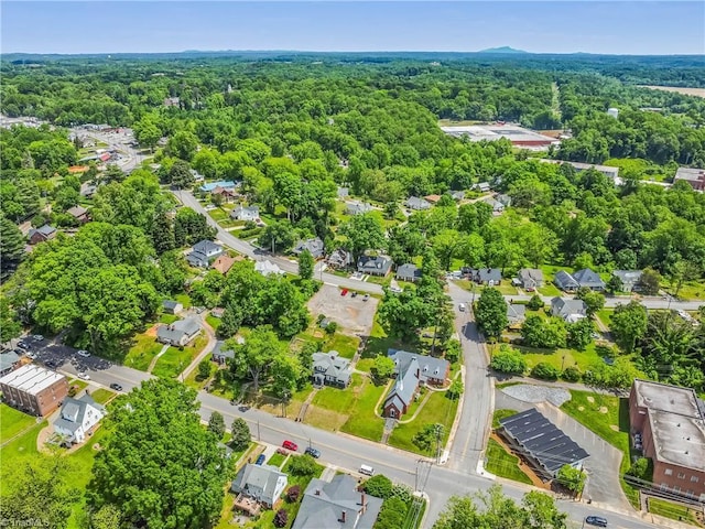 aerial view of residential area with a heavily wooded area