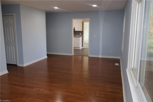 unfurnished room featuring dark hardwood / wood-style floors