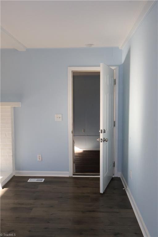 interior space featuring dark hardwood / wood-style flooring and crown molding