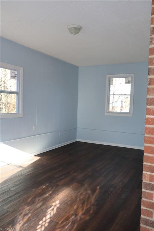 spare room featuring dark hardwood / wood-style flooring