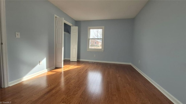 unfurnished bedroom with hardwood / wood-style floors