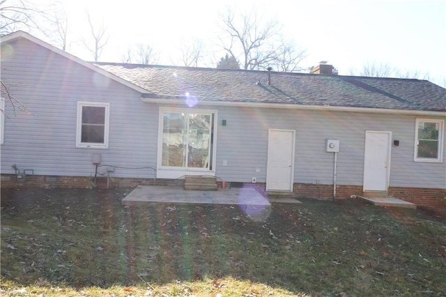 rear view of property featuring a lawn and a patio