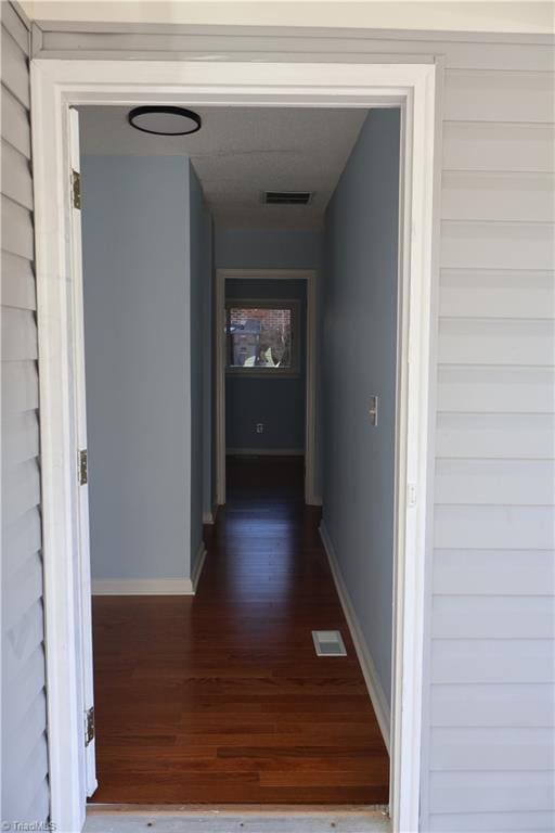 corridor featuring dark hardwood / wood-style flooring