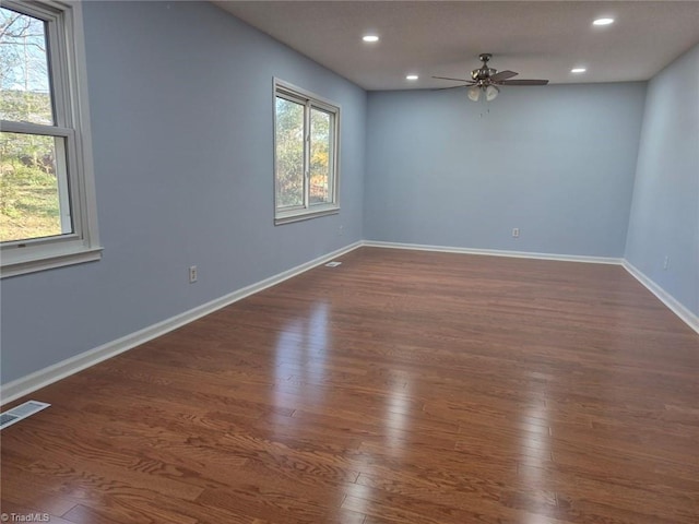 empty room featuring ceiling fan and dark wood-type flooring