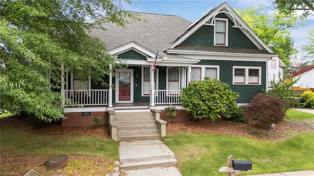 420 Mcadoo Ave, Greensboro, NC 27406 - view of front of home featuring covered porch, roof with shingles, and a front yard