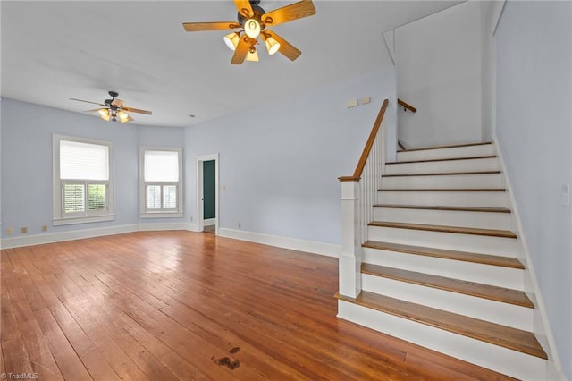 420 Mcadoo Ave, Greensboro, NC 27406 - unfurnished living room featuring a ceiling fan, hardwood / wood-style flooring, stairs, and baseboards