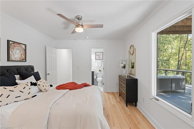 bedroom with ensuite bath, light wood-type flooring, crown molding, and ceiling fan