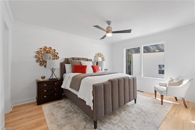 bedroom featuring crown molding, light wood-type flooring, and ceiling fan