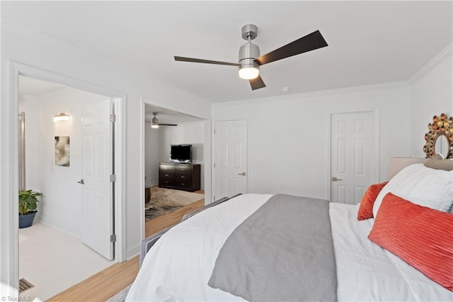 bedroom featuring crown molding, hardwood / wood-style flooring, and ceiling fan