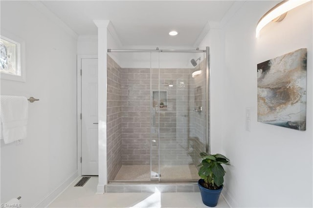 bathroom with ornamental molding, a shower with door, and tile patterned floors