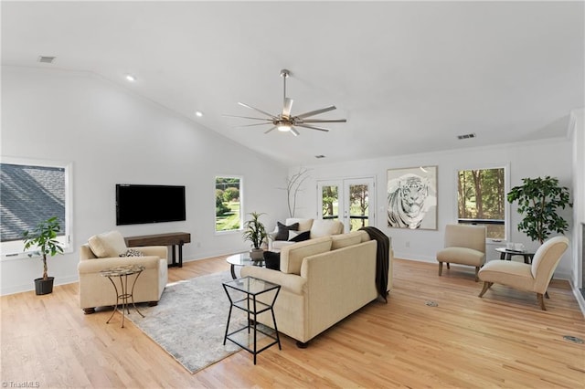 living room with ceiling fan, light hardwood / wood-style flooring, french doors, and vaulted ceiling