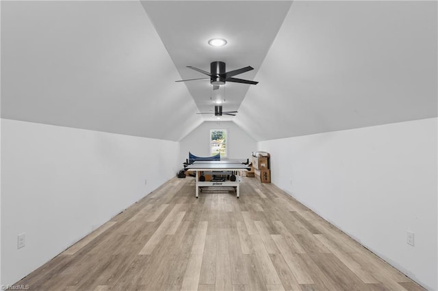 recreation room with ceiling fan, light wood-type flooring, and vaulted ceiling