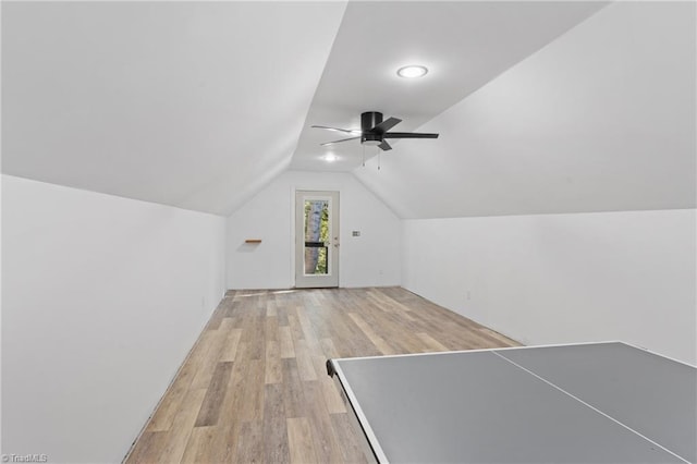 rec room with ceiling fan, light wood-type flooring, and vaulted ceiling