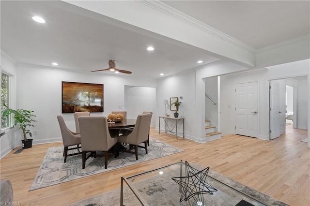 dining area featuring crown molding, light wood-type flooring, and ceiling fan