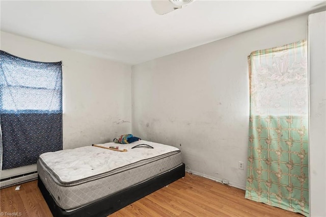 1020 Duchess Ct, Winston-Salem, NC 27107 - bedroom with wood finished floors and a baseboard radiator