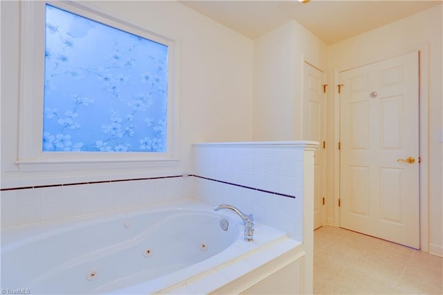 bathroom featuring tile patterned flooring and tiled tub