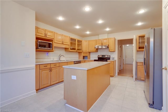 kitchen featuring light brown cabinetry, a kitchen island, stainless steel appliances, and sink