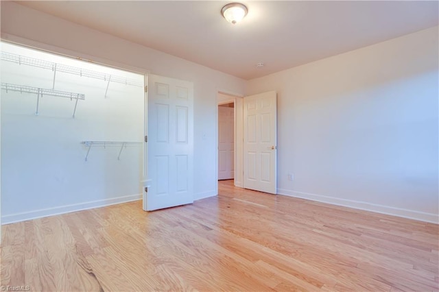 unfurnished bedroom with a closet and light hardwood / wood-style flooring