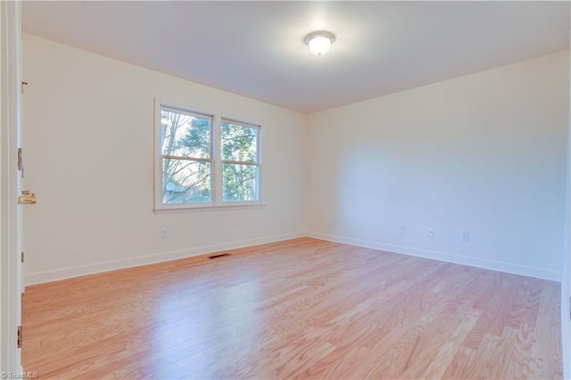 spare room with light hardwood / wood-style flooring