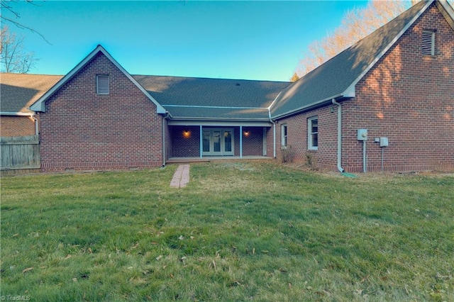 back of house featuring a lawn